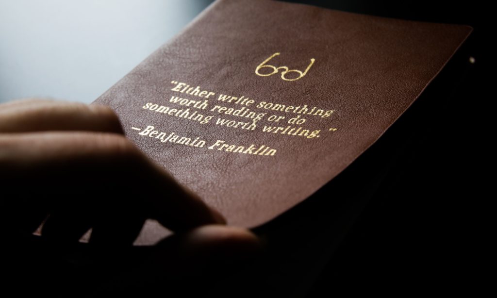 leather book with benjamin franklin quote
