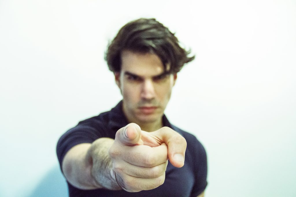 Closeup of young man pointing finger