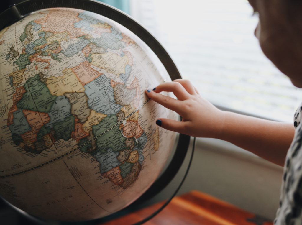young person touching a globe