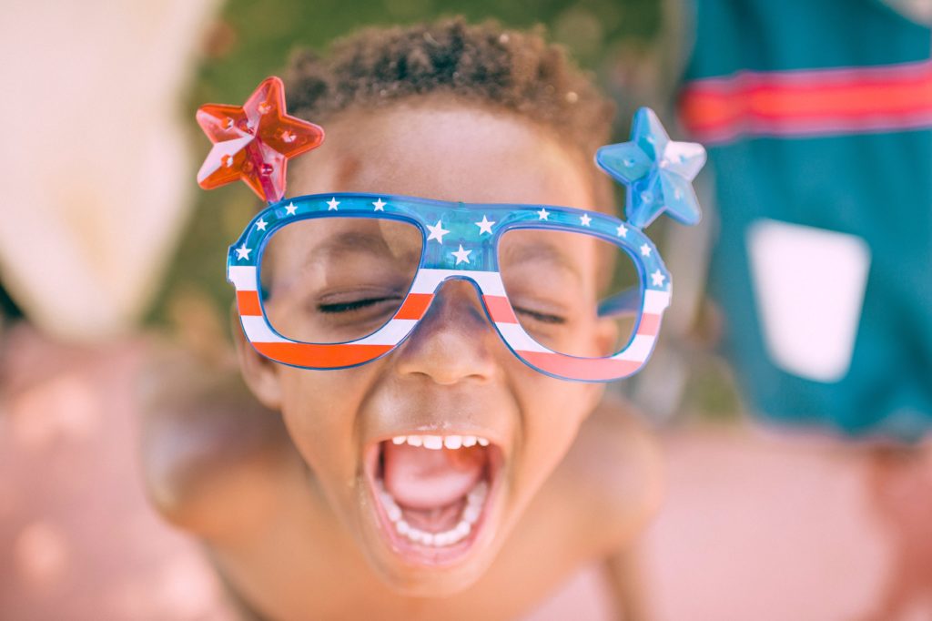young boy with large glasses in flag pattern
