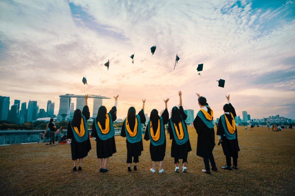 graduates tossing caps in the air